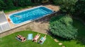 Happy family relaxing by swimming pool, aerial drone view from above of parents and kids have fun on vacation, family weekend Royalty Free Stock Photo