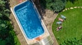 Happy family relaxing by swimming pool, aerial drone view from above of parents and kids have fun on vacation, family weekend Royalty Free Stock Photo