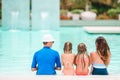 Happy family of four in outdoors swimming pool Royalty Free Stock Photo