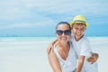 Happy family resting at beach in summer. Mother with boy resting on the beach. Young mother and her adorable little son Royalty Free Stock Photo