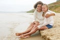 Happy family resting on a sandy beach Royalty Free Stock Photo