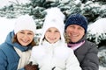 Happy family resting in the winter forest.