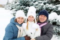 Happy family resting in the winter forest.