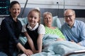 Happy family reunited in grandmother recovery hospital room Royalty Free Stock Photo