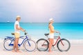 Happy family riding bicycles on the beach Royalty Free Stock Photo