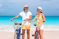 Happy family riding bicycles on the beach Royalty Free Stock Photo