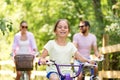 Happy family riding bicycles in summer park Royalty Free Stock Photo