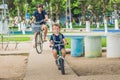 Happy family is riding bikes outdoors and smiling. Father on a b Royalty Free Stock Photo