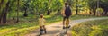 Happy family is riding bikes outdoors and smiling. Father on a bike and son on a balancebike BANNER, long format Royalty Free Stock Photo