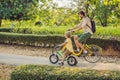 Happy family is riding bikes outdoors and smiling. Father on a bike and son on a balancebike Royalty Free Stock Photo