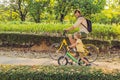 Happy family is riding bikes outdoors and smiling. Father on a bike and son on a balancebike Royalty Free Stock Photo