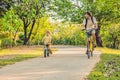 Happy family is riding bikes outdoors and smiling. Father on a bike and son on a balancebike Royalty Free Stock Photo