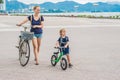 Happy family is riding bikes outdoors and smiling. Mom on a bike Royalty Free Stock Photo