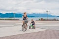 Happy family is riding bikes outdoors and smiling. Mom on a bike Royalty Free Stock Photo