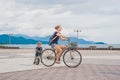 Happy family is riding bikes outdoors and smiling. Mom on a bike and son on a balancebike Royalty Free Stock Photo