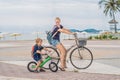 Happy family is riding bikes outdoors and smiling. Mom on a bike Royalty Free Stock Photo