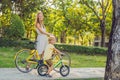 Happy family is riding bikes outdoors and smiling. Mom on a bike and son on a balancebike Royalty Free Stock Photo