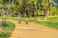 Happy family is riding bikes outdoors and smiling. Mom on a bike and son on a balancebike Royalty Free Stock Photo