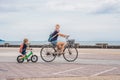 Happy family is riding bikes outdoors and smiling. Mom on a bike Royalty Free Stock Photo