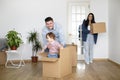 Happy Family Riding Their Son In Cardboard Box While On Moving Day Royalty Free Stock Photo