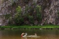 Happy family on river having fun and splashing water in summer. children play with father