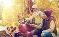 Happy family roasting marshmallow over campfire Royalty Free Stock Photo