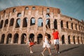 Happy family in Europe. Parents and kids in Rome over Coliseum background Royalty Free Stock Photo