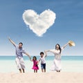 Happy family run at beach under love cloud Royalty Free Stock Photo