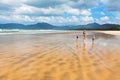 Happy family run by wide sand beach Royalty Free Stock Photo