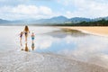 Happy family run by wide sand beach Royalty Free Stock Photo