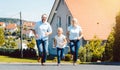 Happy family running in front of their new home Royalty Free Stock Photo