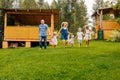 Happy family running in garden on grass. Royalty Free Stock Photo