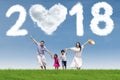 Happy family running under numbers 2018 Royalty Free Stock Photo