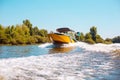 Happy family sailing a motorboat down the river Royalty Free Stock Photo