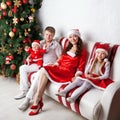 Happy family in Santa costumes celebrating Christmas. Royalty Free Stock Photo