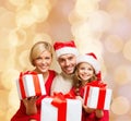 Happy family in santa helper hats with gift boxes Royalty Free Stock Photo