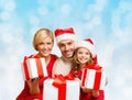 Happy family in santa helper hats with gift boxes Royalty Free Stock Photo