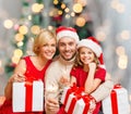 Happy family in santa helper hats with gift boxes Royalty Free Stock Photo