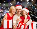 Happy family in santa helper hats with gift boxes Royalty Free Stock Photo