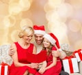 Happy family in santa helper hats with gift boxes Royalty Free Stock Photo