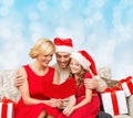 Happy family in santa helper hats with gift boxes Royalty Free Stock Photo