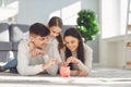 Happy family saves money in a piggy bank pig. Royalty Free Stock Photo