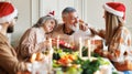 Happy family sharing gifts on Christmas morning, young and elderly couple exchanging xmas presents