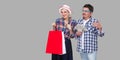 Happy family after shopping, adult man and woman in casual checkered shirt standing together,wife holding paper bag with toothy Royalty Free Stock Photo