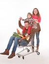 Happy family with a shopping cart in supermarket Royalty Free Stock Photo