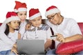 Happy family shopping online at Christmas time Royalty Free Stock Photo