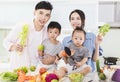 Happy family showing healthy food in kitchen