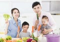 Happy family showing healthy food in kitchen