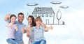 Happy family showing thumbs up sign with house in background Royalty Free Stock Photo