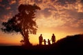 Happy family silhouette standing on against sunset time Royalty Free Stock Photo
